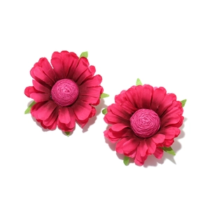 Detailed close-up of handmade fabric daisy earrings with vibrant magenta petals