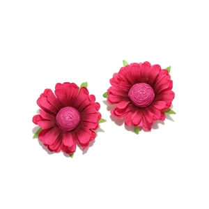 Detailed close-up of dark pink fabric flower earrings with green leaf accents and stamen