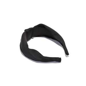 Close-up of black satin knotted wide headband with a subtle glossy finish