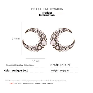 Detailed view of crescent moon earrings with rhinestones and vintage gold finish