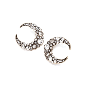Vintage gold crescent moon earrings encrusted with sparkling crystals on white background