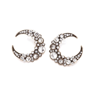 Vintage gold crescent moon earrings with rhinestones on a white background