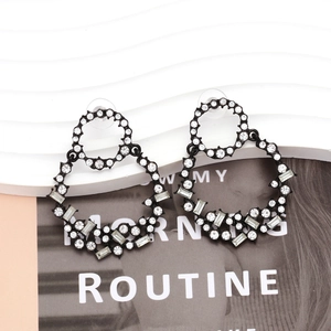Macro detail of gothic style alloy earrings featuring black finish and pavé white rhinestones
