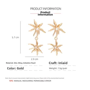 Detail view of gold flower drop earrings with pearls showing dimensions 5.7cm x 2.9cm