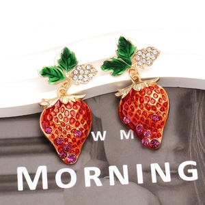 Detail of strawberry drop earring featuring red enamel gradient and sparkling rhinestones