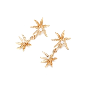 Elegant gold flower earrings with white pearls in a vintage minimalist aesthetic