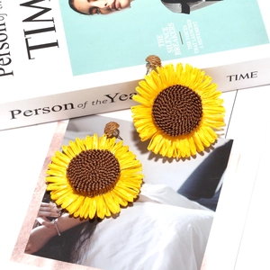 Handmade woven raffia sunflower drop earrings with yellow petals and brown woven core
