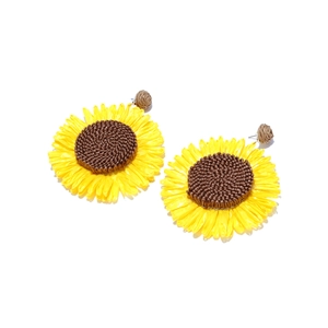 Detailed view of handmade raffia sunflower earrings with woven petals and brown core