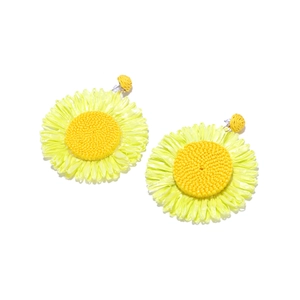 Detailed view of handmade raffia sunflower earrings with woven petals and yellow core
