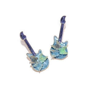Detail of guitar-shaped stud earrings with blue enamel finish and butterfly accents
