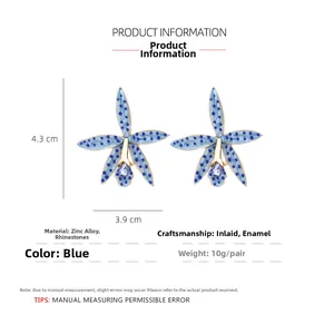 Detailed size view of orchid-shaped blue drop oil earrings with purple rhinestones
