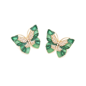 Detail of gold butterfly earrings with green enamel wings and white pearl accents