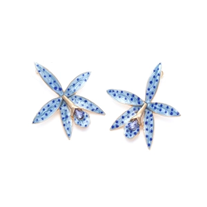 Macro detail of orchid flower earrings with blue enamel petals and purple crystal core