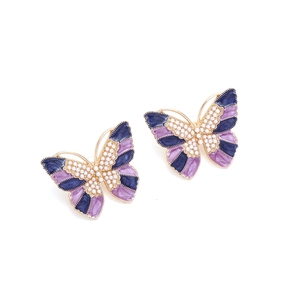 Vintage gold butterfly earrings with purple enamel wings and white pearl accents