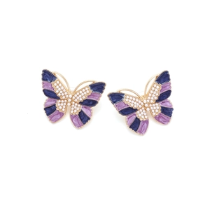 Macro detail of butterfly earrings with purple enamel coating and small white pearls