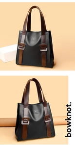 Close-up of litchi texture faux leather tote bag with contrasting brown straps and kangaroo logo