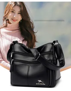 Detail of soft black leather crossbody bag with multiple zippers and adjustable strap