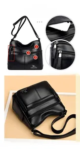 Detail of black textured leather bag featuring multiple zipper pockets and gold kangaroo logo