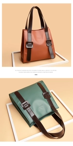 Close-up of litchi grain leather tote bag with embossed kangaroo logo and double buckles
