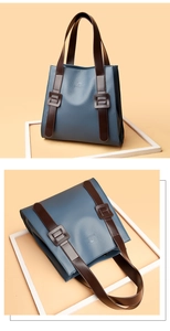 Detail of blue pebble leather tote with brown strap and branded kangaroo embossing