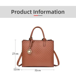 Detail view of brown quilted handbag with dimensions and golden leaf charm ornament