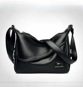 Detailed close-up of grain leather texture and metallic kangaroo logo on black shoulder bag