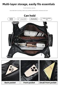 Detail view of washed leather tote interior compartments and front anti-theft zipper pockets