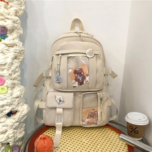 Sac à dos d'école crème pour femmes avec poches transparentes et breloques de dessins