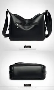 Detail view of the black pebble leather crossbody bag showing back zipper and bottom structure