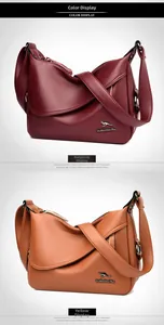 Close-up of pebble leather texture and kangaroo logo on burgundy and yellow bags