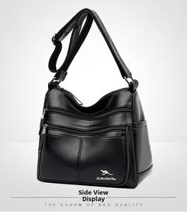 Side view of black lychee grain leather crossbody bag featuring kangaroo logo and zippers