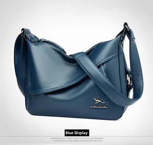 Detail of blue litchi pattern leather shoulder bag with golden kangaroo logo and stitching