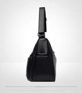 Side view of black lychee leather crossbody bag showing large capacity and stitching