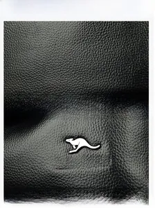 Detailed view of black litchi pattern leather texture and silver kangaroo logo metal hardware