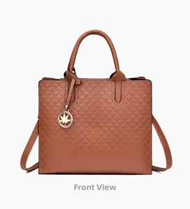 Detailed front view of brown quilted PU leather handbag with golden leaf pendant