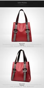 Detail of wine red pebbled leather handbag with metal buckle and embossed kangaroo logo