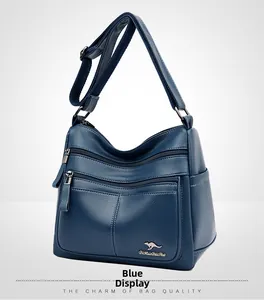Blue faux leather crossbody bag with multiple zippers and golden kangaroo logo detail