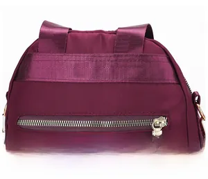 Détails des bretelles renforcées et du zip doré sur le sac à dos en nylon violet