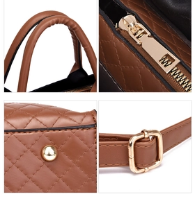 Detail view of brown quilted faux leather bag with golden hardware and handles