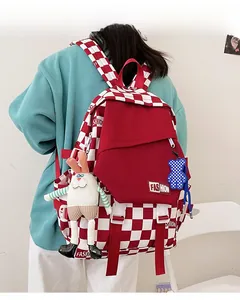 Detail of red and white checkered backpack with decorative rabbit and bear charms