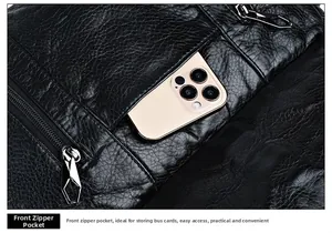 Close-up of black leather bag featuring pebbled texture and functional front zip pocket
