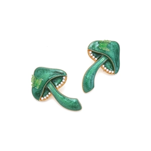 Close-up of green mushroom earrings with white pearls and a gold butterfly charm