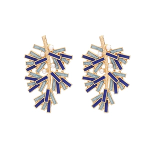 Artistic gold branch earrings with blue enamel leaves and white pearls on white background