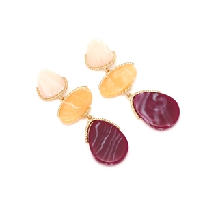 Detail of geometric resin drop earrings featuring pink, yellow and purple tiered pendants