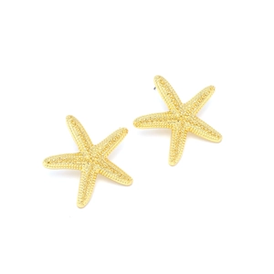 Golden alloy starfish earrings with detailed textured surface on white background