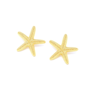 Detailed macro view of gold starfish stud earrings with realistic textured surface finish