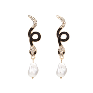 Golden snake earrings with white rhinestones and dangling baroque pearls on white background