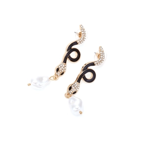 Detail of gold snake earrings with black enamel, white crystals and baroque pearl drop
