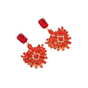 Detail of flower-shaped earrings featuring red crystals and gold-plated alloy base