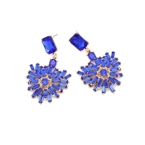 Detail of luxury royal blue heart earrings with starry rhinestone drops and gold finish